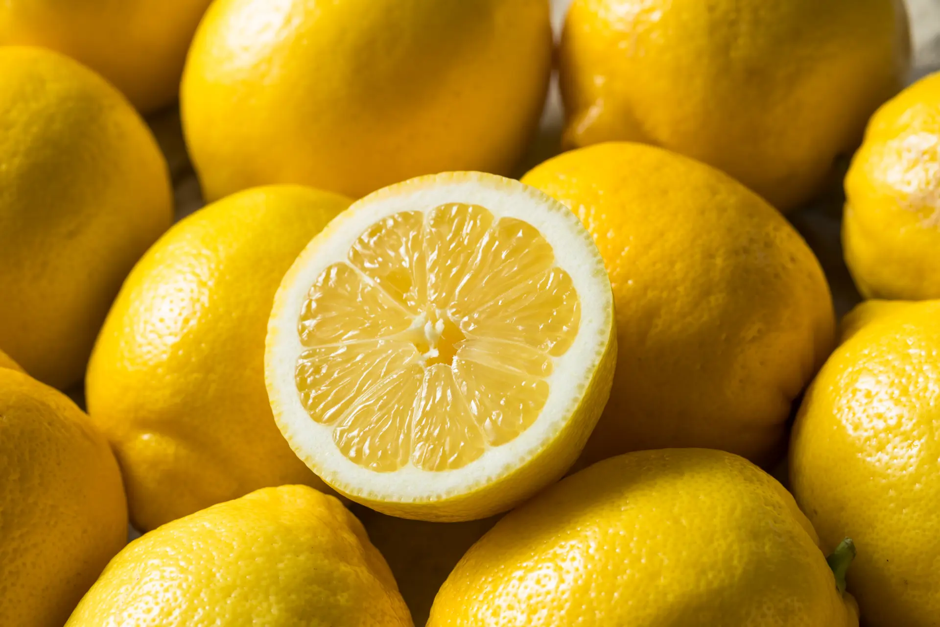Fresh organic lemons, one sliced open